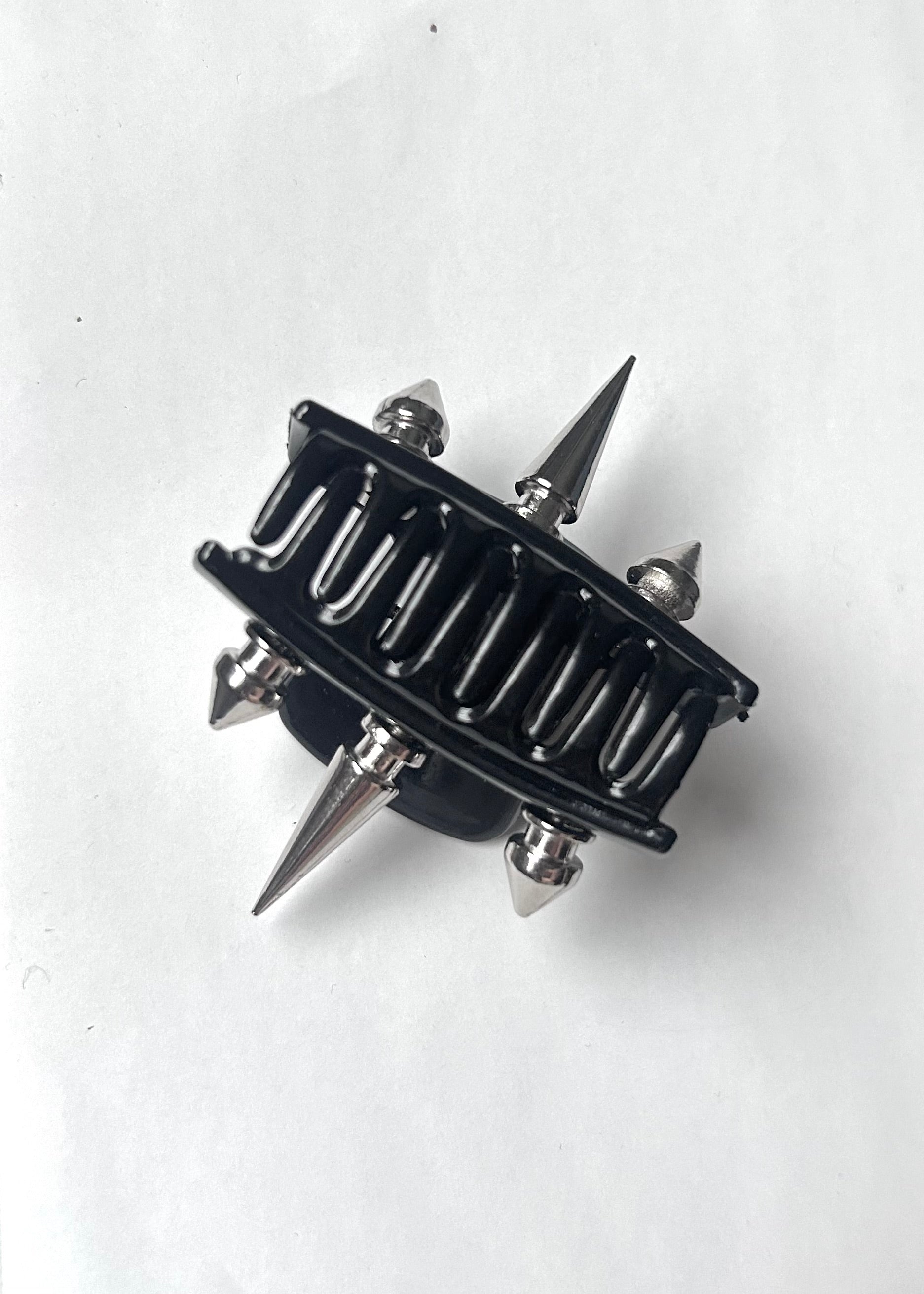Black and silver spiked claw clip on a white background