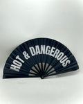 Black hand-fan with printed words “HOT & DANGEROUS”