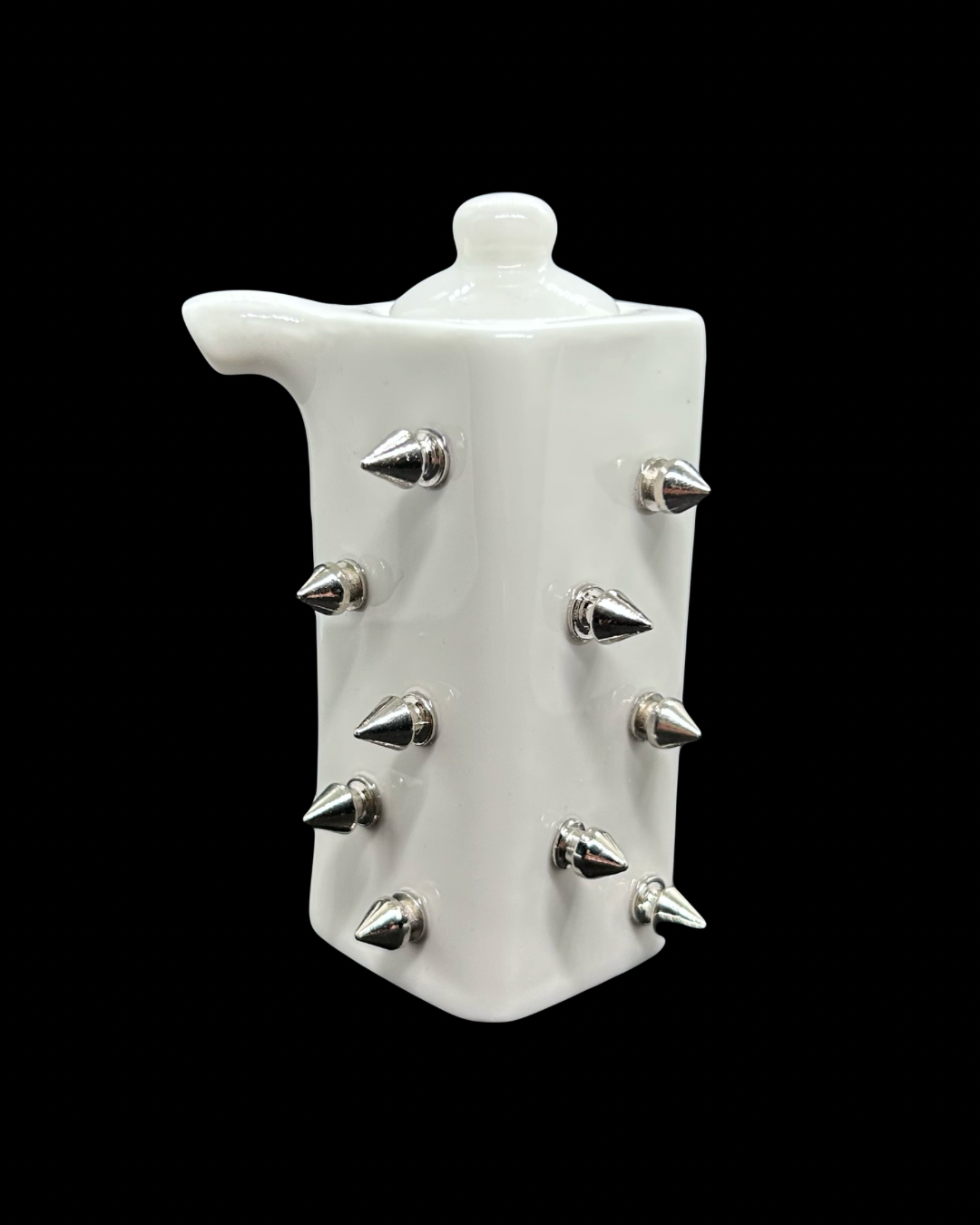 Small white ceramic soy sauce container with spikes attached