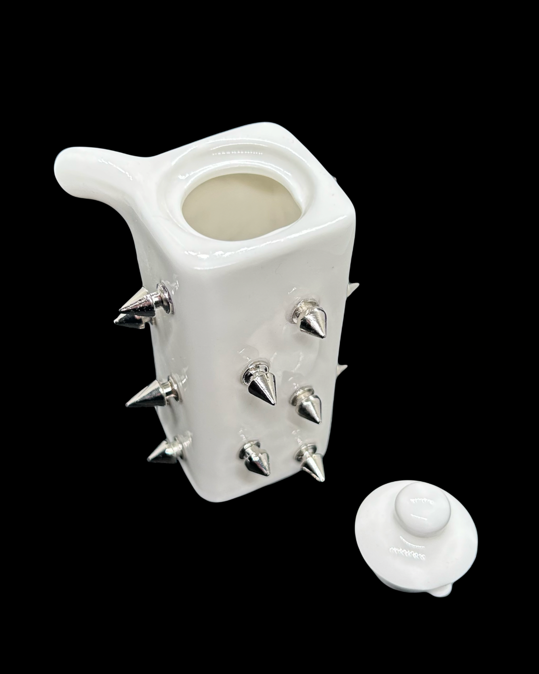 Small white ceramic soy sauce container with spikes attached
