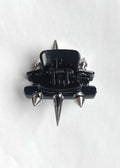 Black and silver spiked claw clip on a white background